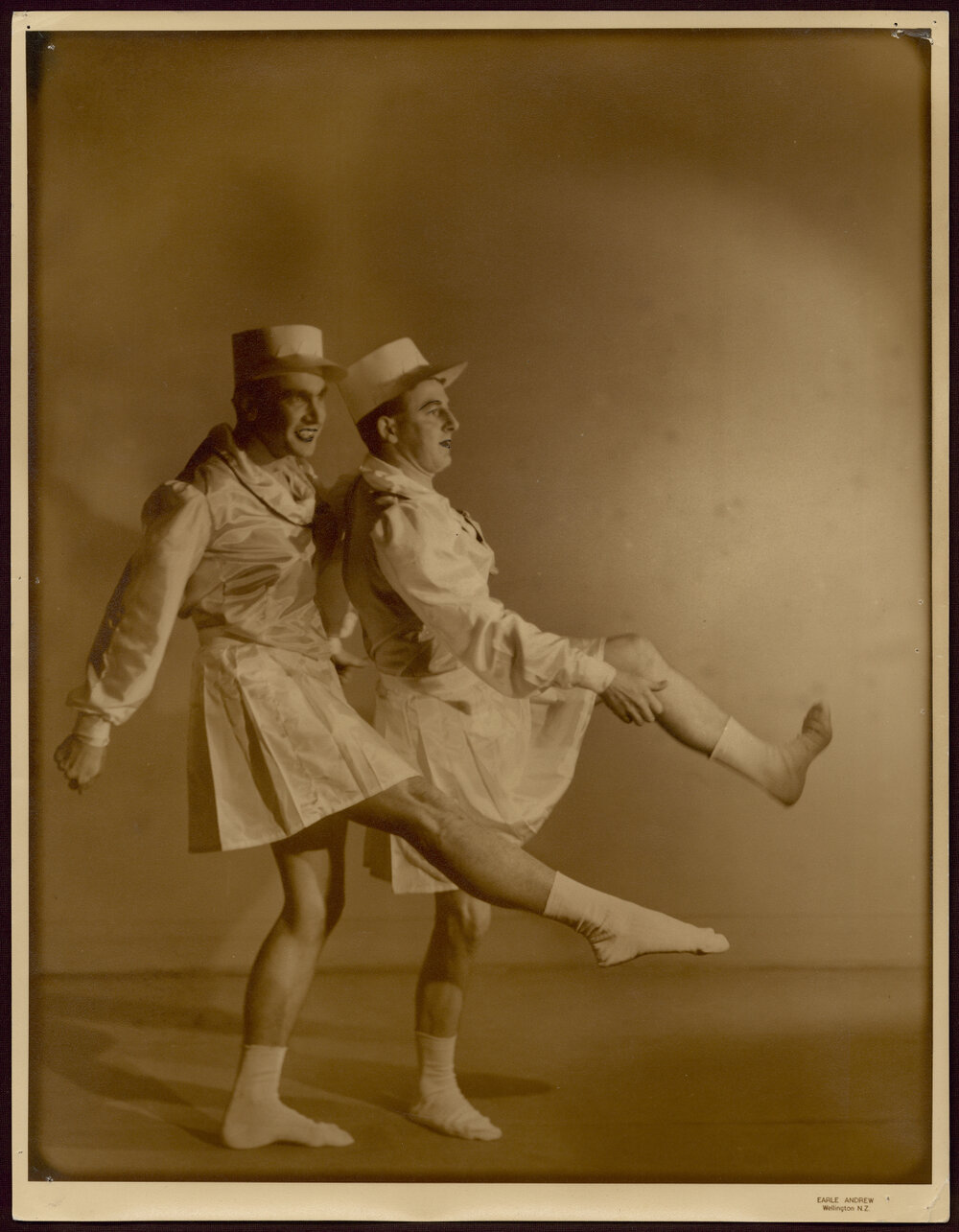 Portrait of two men dancing in drag