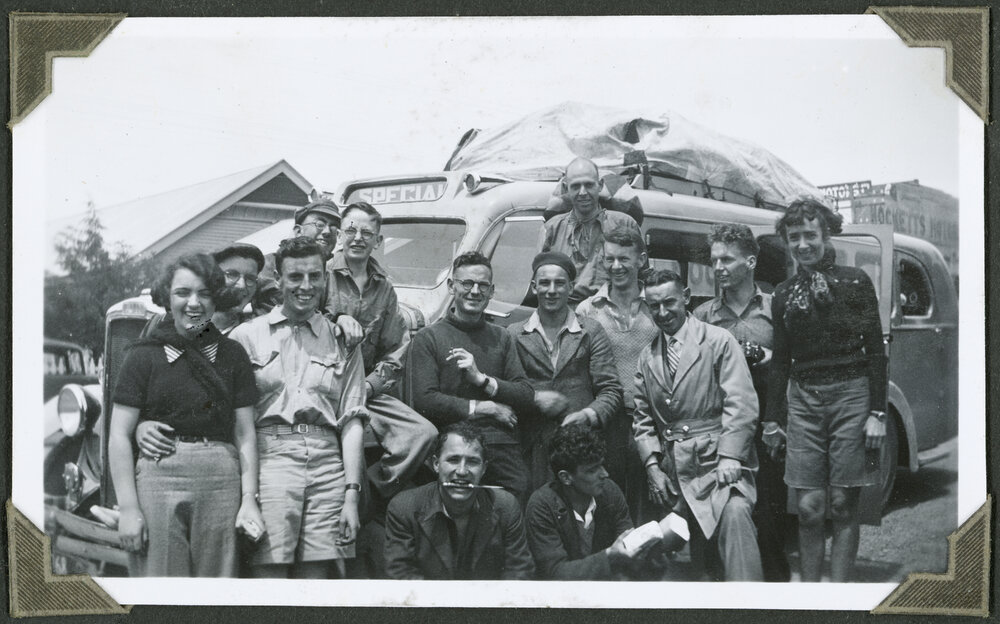 [Group image of people in front of a bus.]