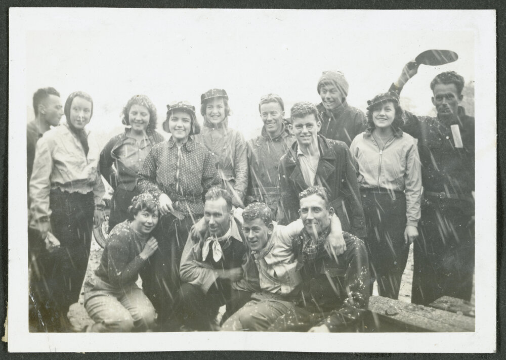 [Group of  people standing outside in the snow.]