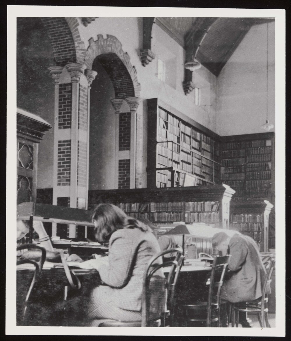 Students working at desk inside the Hunter Library