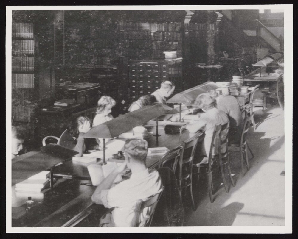 Students working at a long table inside the Hunter Library