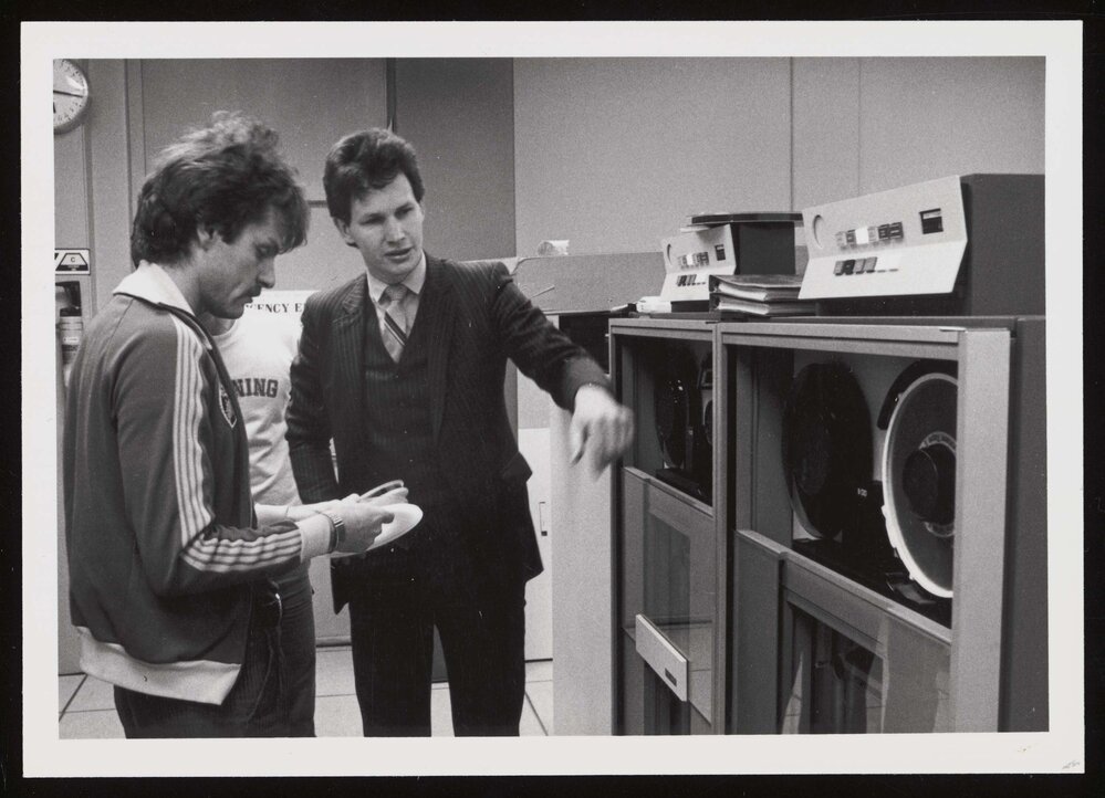 Two people in a computer stack room