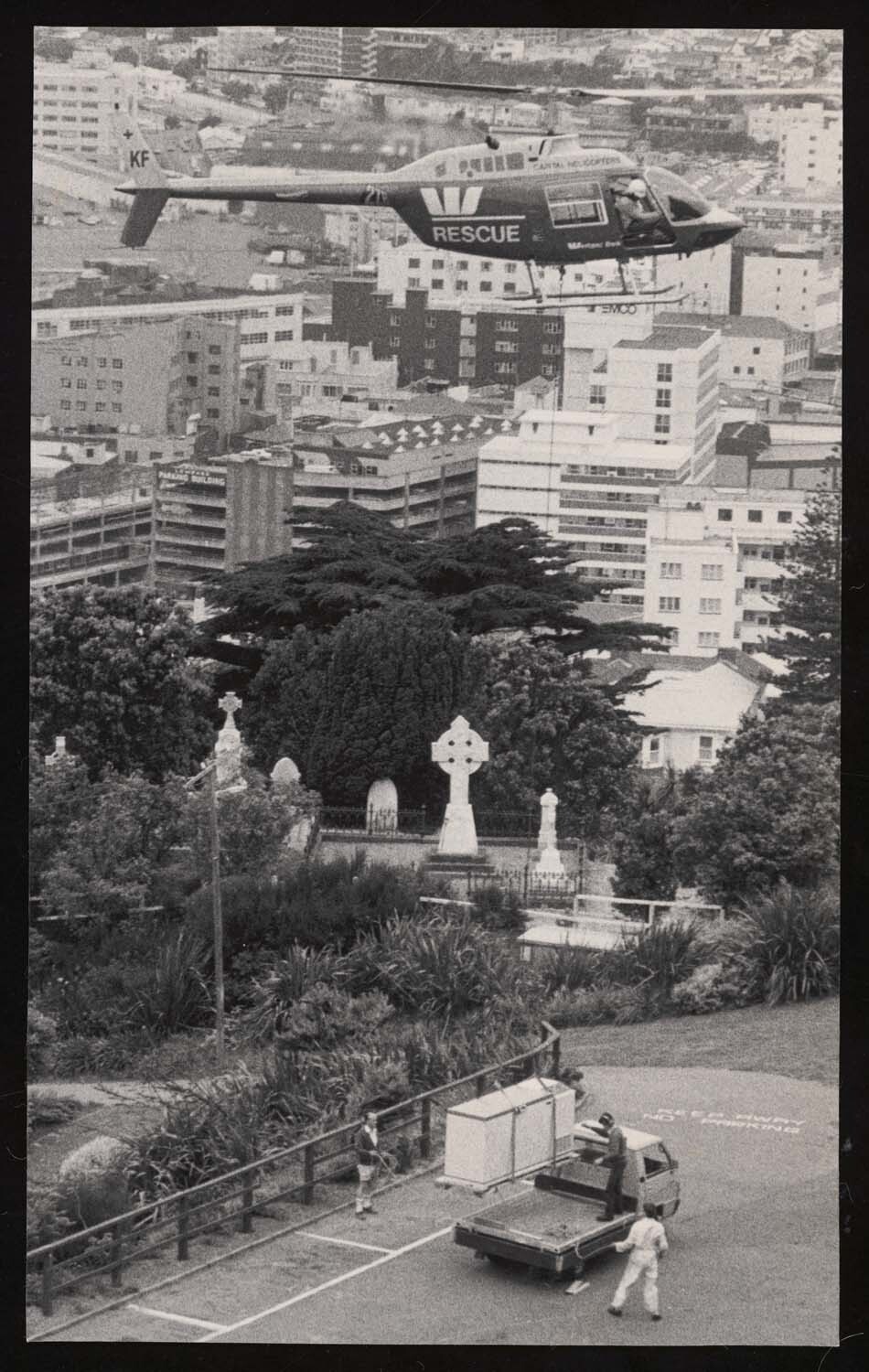 Helicopter lifts new deep freeze off a truck near Mount Street Cemetary