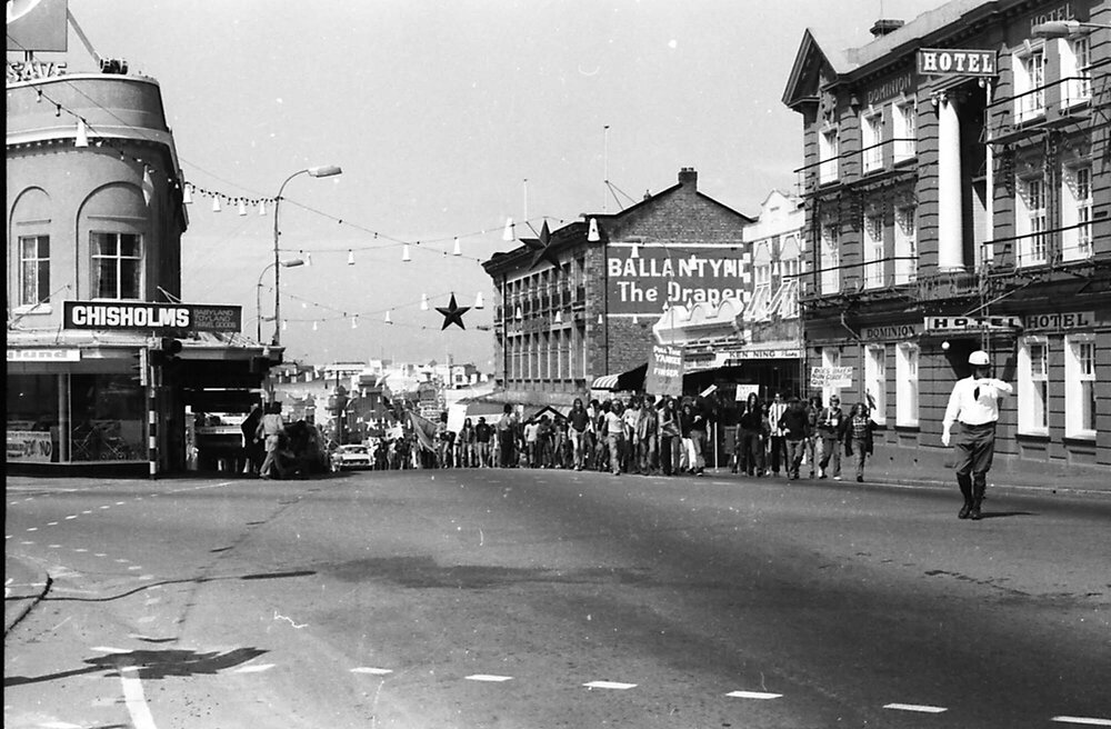 Anti US military base demonstrators walking along Stafford St, Timaru