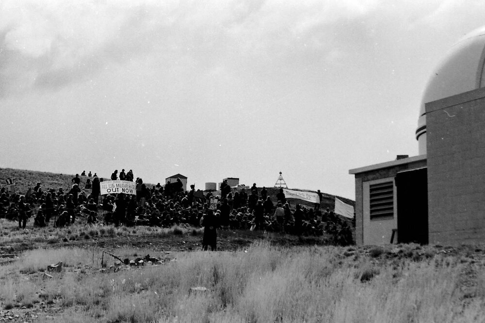 Anti US military base demonstrators sitting in front of the Ōtehīwai Mt John observatory