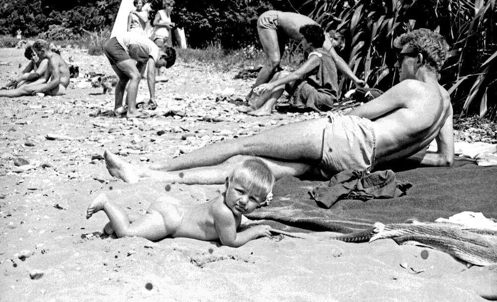 Family on the beach at Curious Cove