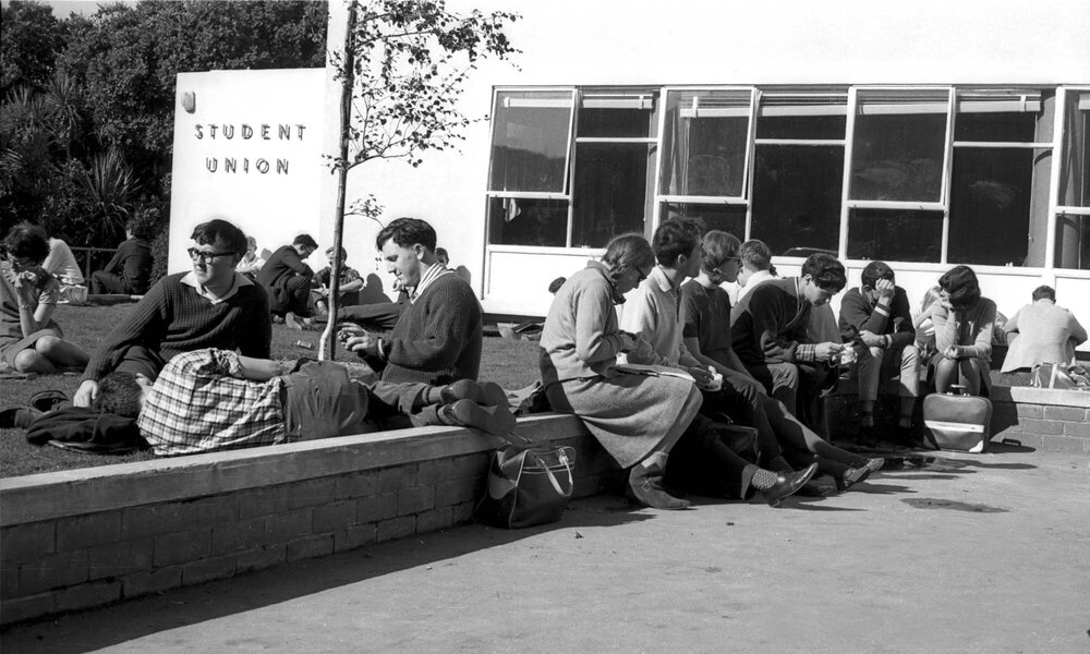 Students relaxing in the sun by Student Union