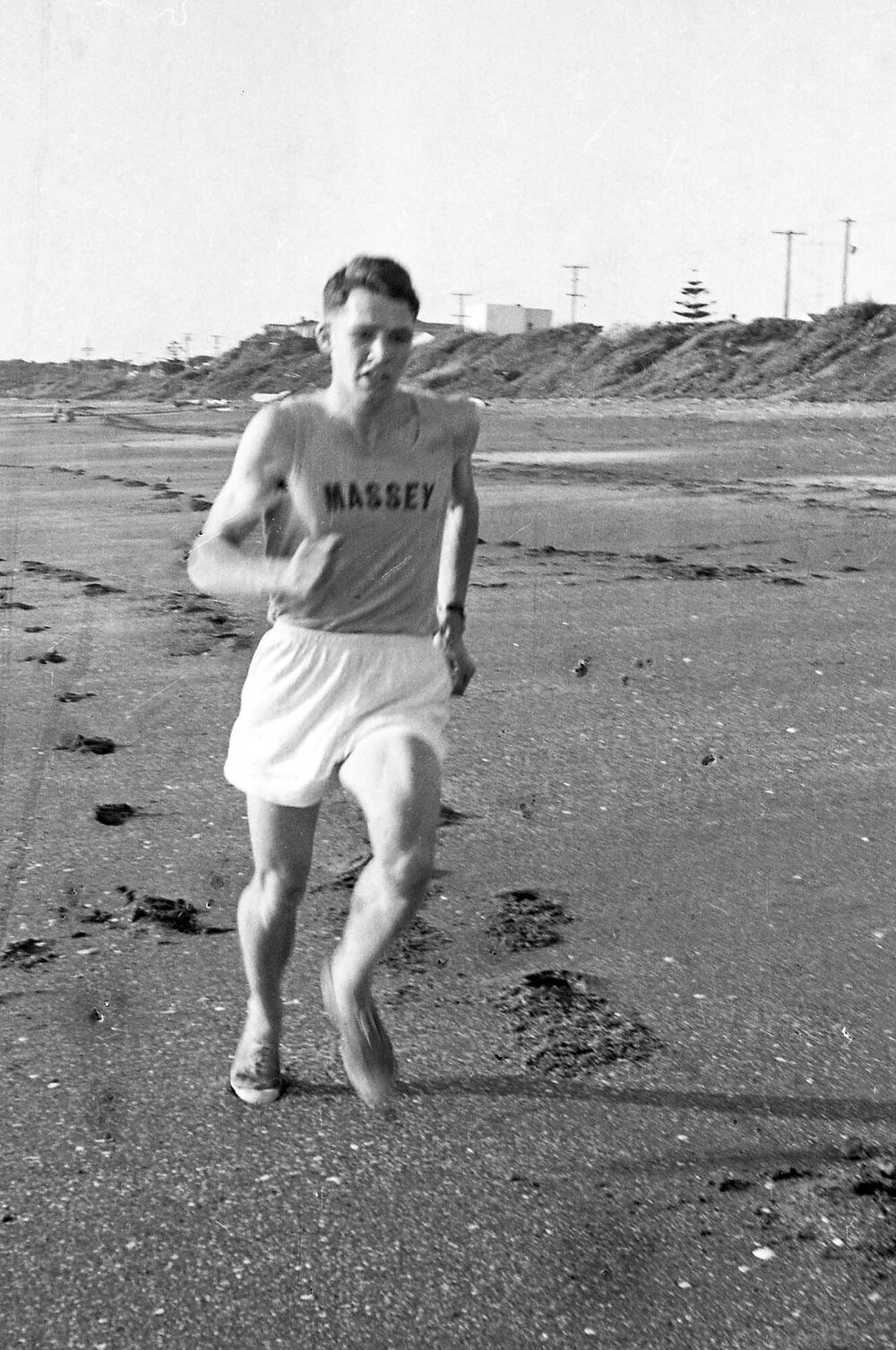 Massey University cross country runner on beach
