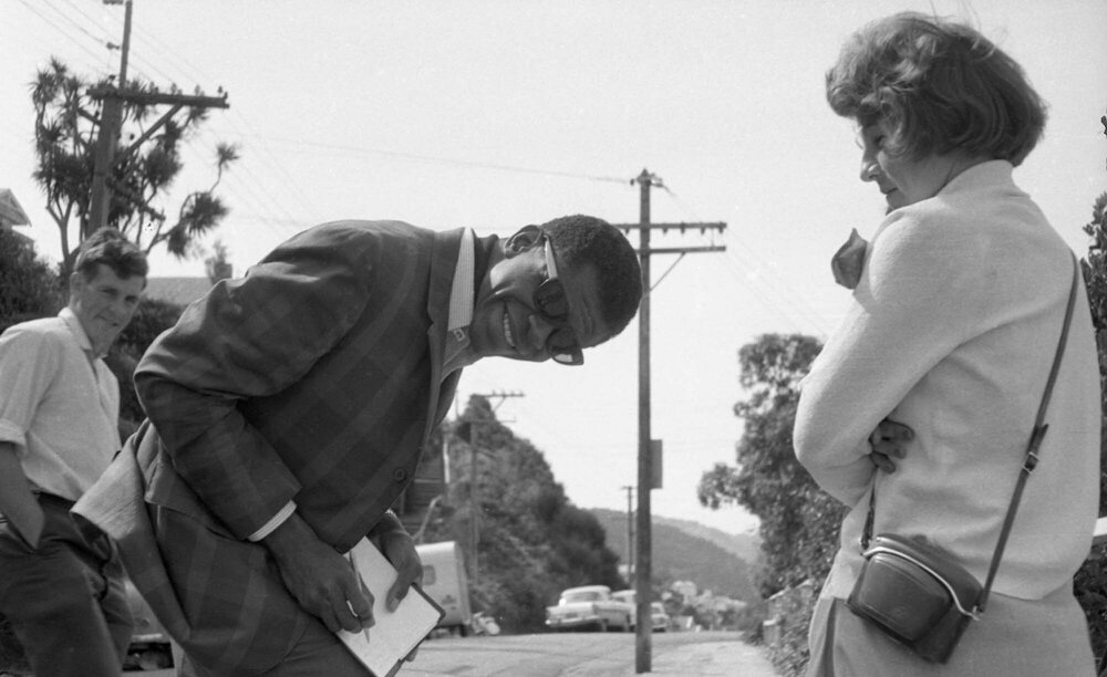 Musician Larry Gales [?] signs autograph 