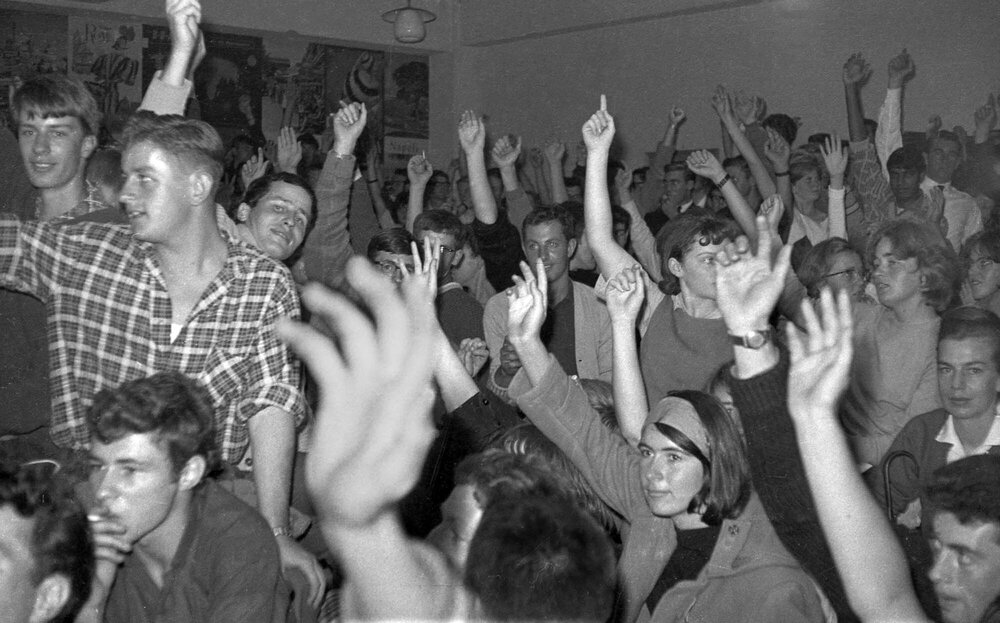 Attendees vote at Victoria University Students' Association meeting on fee increases