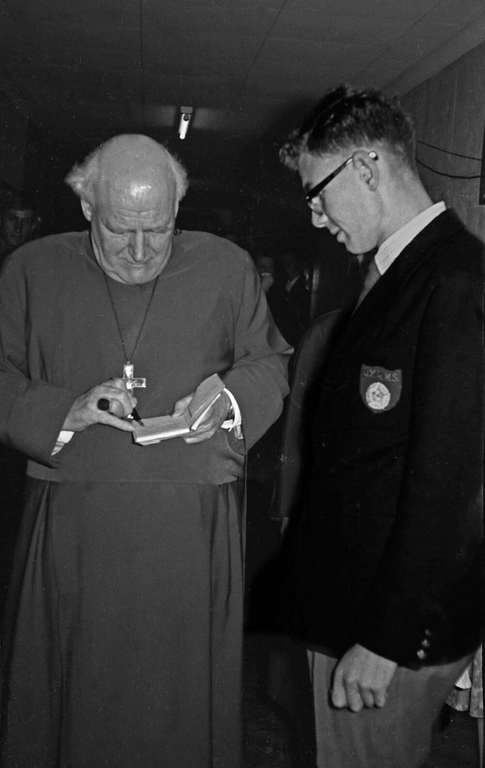 Canon Hugh Montefiore signing an autograph