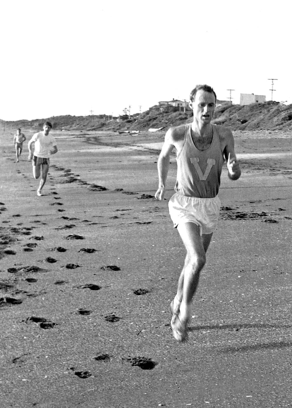 Weir House Warden Dr Tim Beaglehole running a cross-country race on the beach