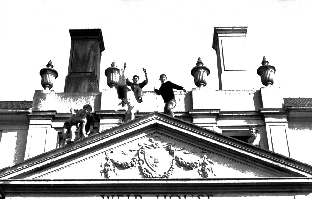 Students posing on the roof of Weir House