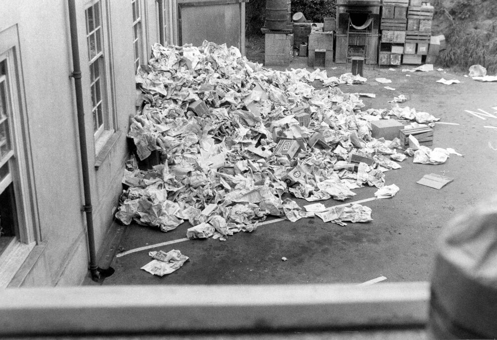 A mountain of newspapers tossed out of a Weir House resident's window