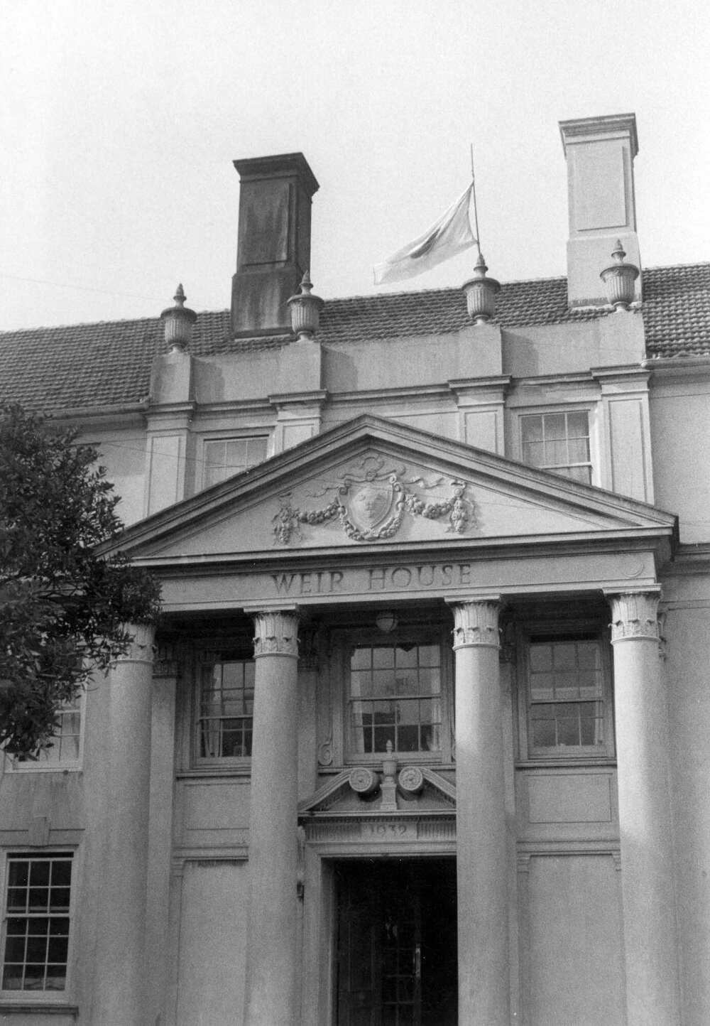 Weir House entrance with rising sun flag