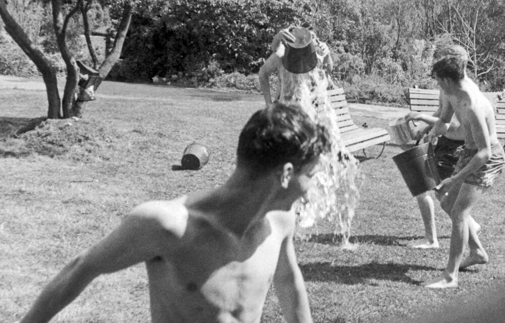 Weir House residents having a water fight on the front lawn
