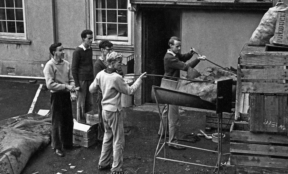 Dr Tim Beaglehole and Weir House residents disposing rubbish