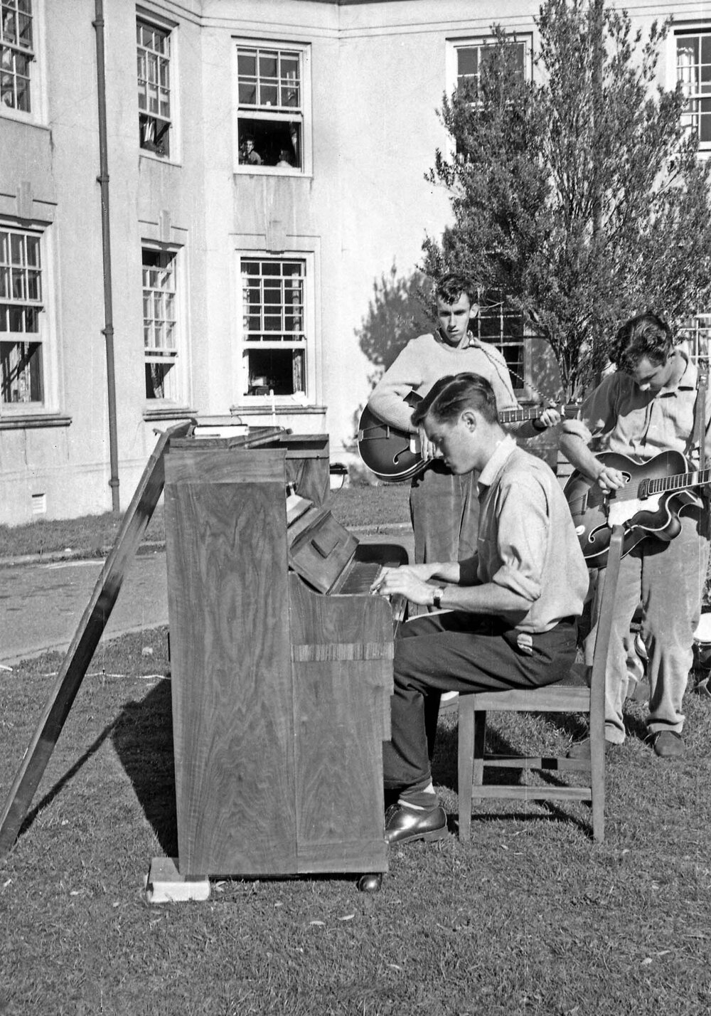 Weir House residents playing piano and guitar on the lawn