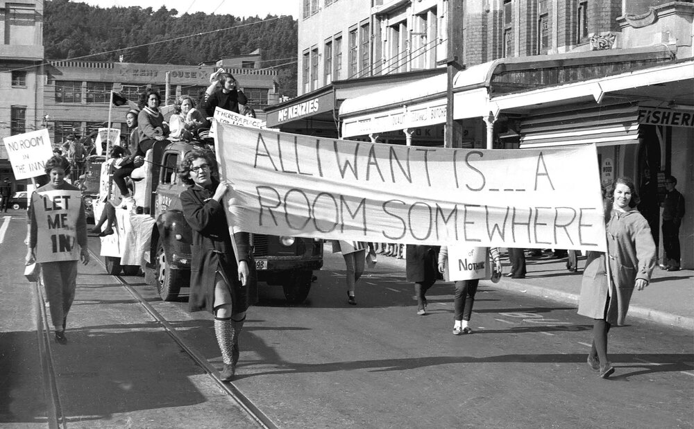 Students holding signs about housing in the annual student procession