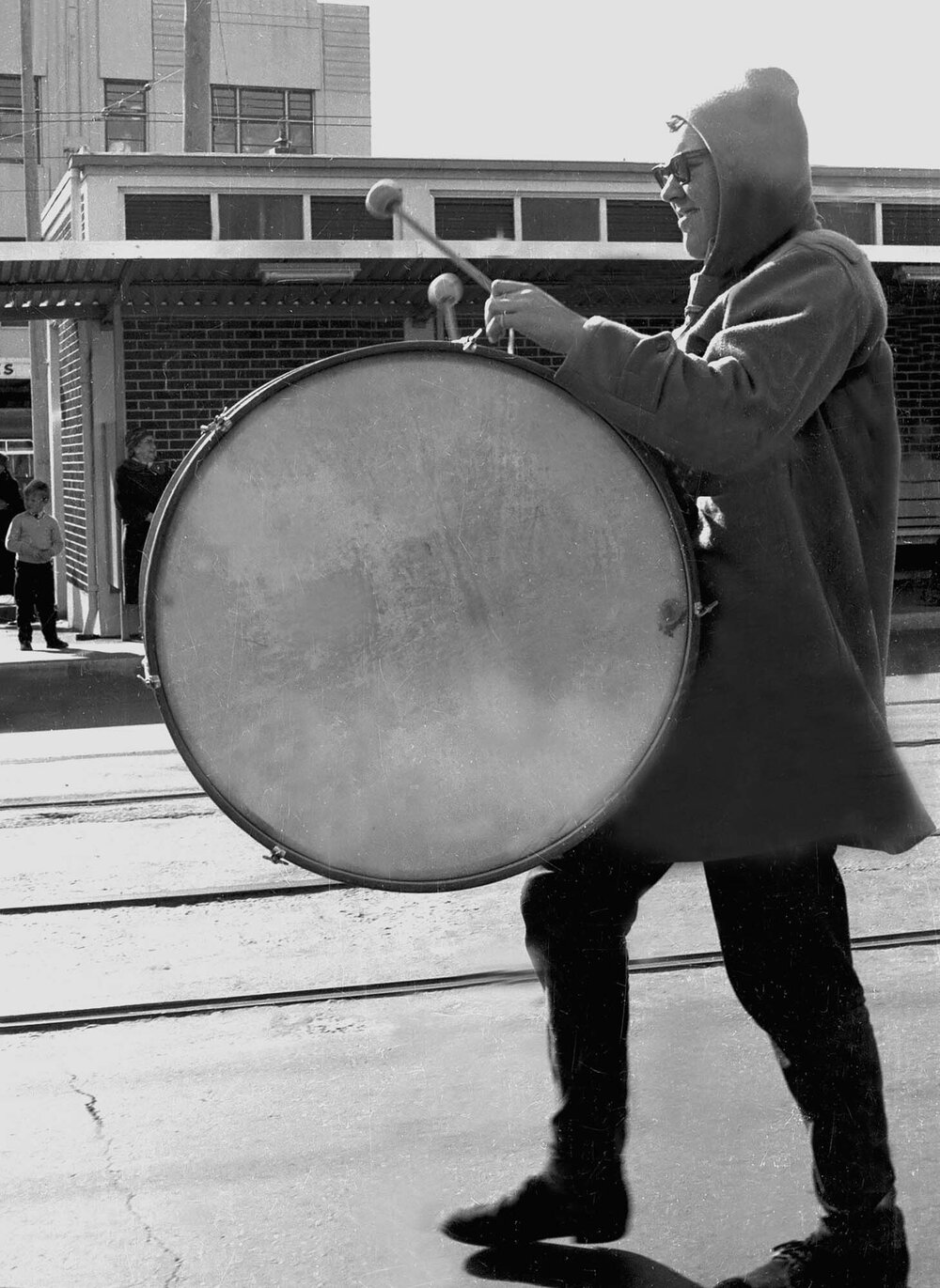 Student in costume playing a marching drum for the annual student procession