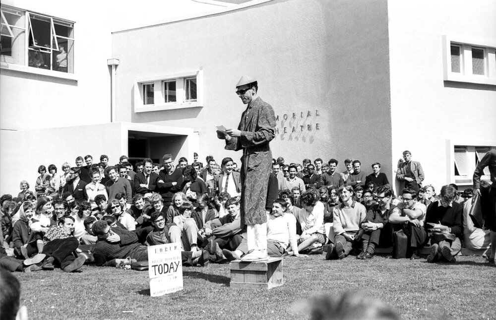 Speaker wearing dressing gown at the weekly student forum 