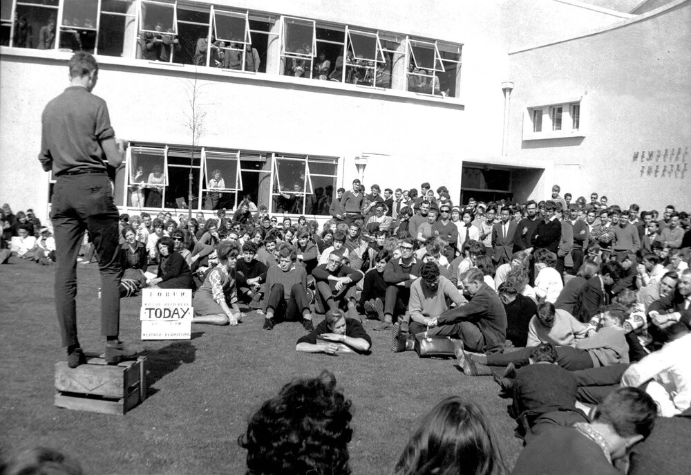 Students listening to a speaker on the soapbox at the weekly student forum
