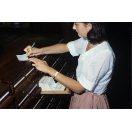 Slide 37 Student writing down card catalogue information