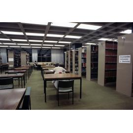Slide 51 Students studying at desks near bibliographies and encyclopedias shelves