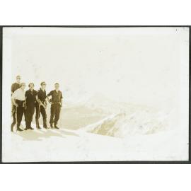 [Image of five people standing on a mountain.]