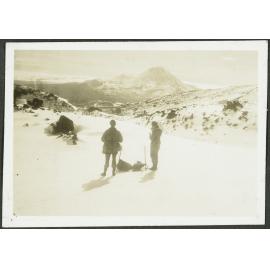 [Image of two people standing in the snow.]