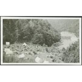 Camp. [Image of tents on a grassy area, taken from above.]