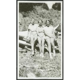 Flora, Kath & Rawi. [Image of three women sitting on a log]