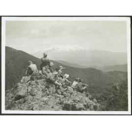 [Image of a group of people atop a mountain.]
