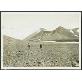Tongariro [Two men standing on rocky scree.]