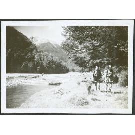 [Image of two women walking beside a river.]