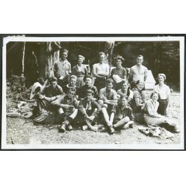 [Group image of the tramping party, standing in front of their campsite.]