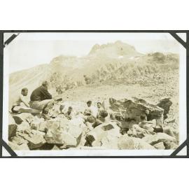 Taruahuna Pass. [Image of the tramping party sitting among boulders.]