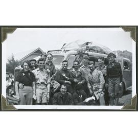 [Group image of people in front of a bus.]