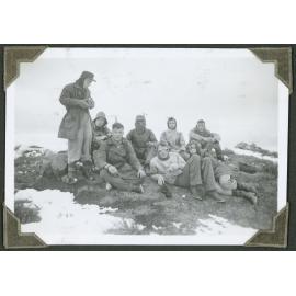 Lunch. [A group of trampers sit down to eat lunch.]