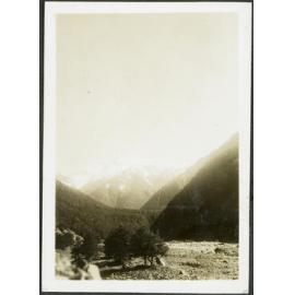[Image of a valley and snowy mountain.]