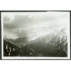 [Image of snowy mountains in clouds.]