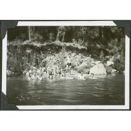 [Group image of people swimming in a river.]