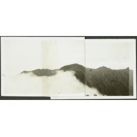 [Image of mountain ranges, partially obscured by cloud]