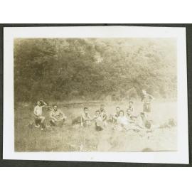 [Image of a group of people sitting in the grass.]