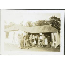 Whakapapa. [Image of a group of people gathered outside a hut.]