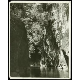 [Image taken from a river, with cliffs and forest surrounding.]