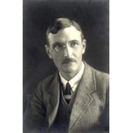 Studio portrait of unidentified man with glasses