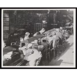 Students working at a long table inside the Hunter Library