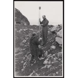 Two researchers taking a measurement on White Island
