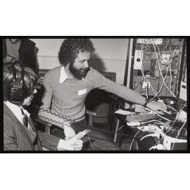 Two people in a psychology laboratory performing a test using electronic equipment